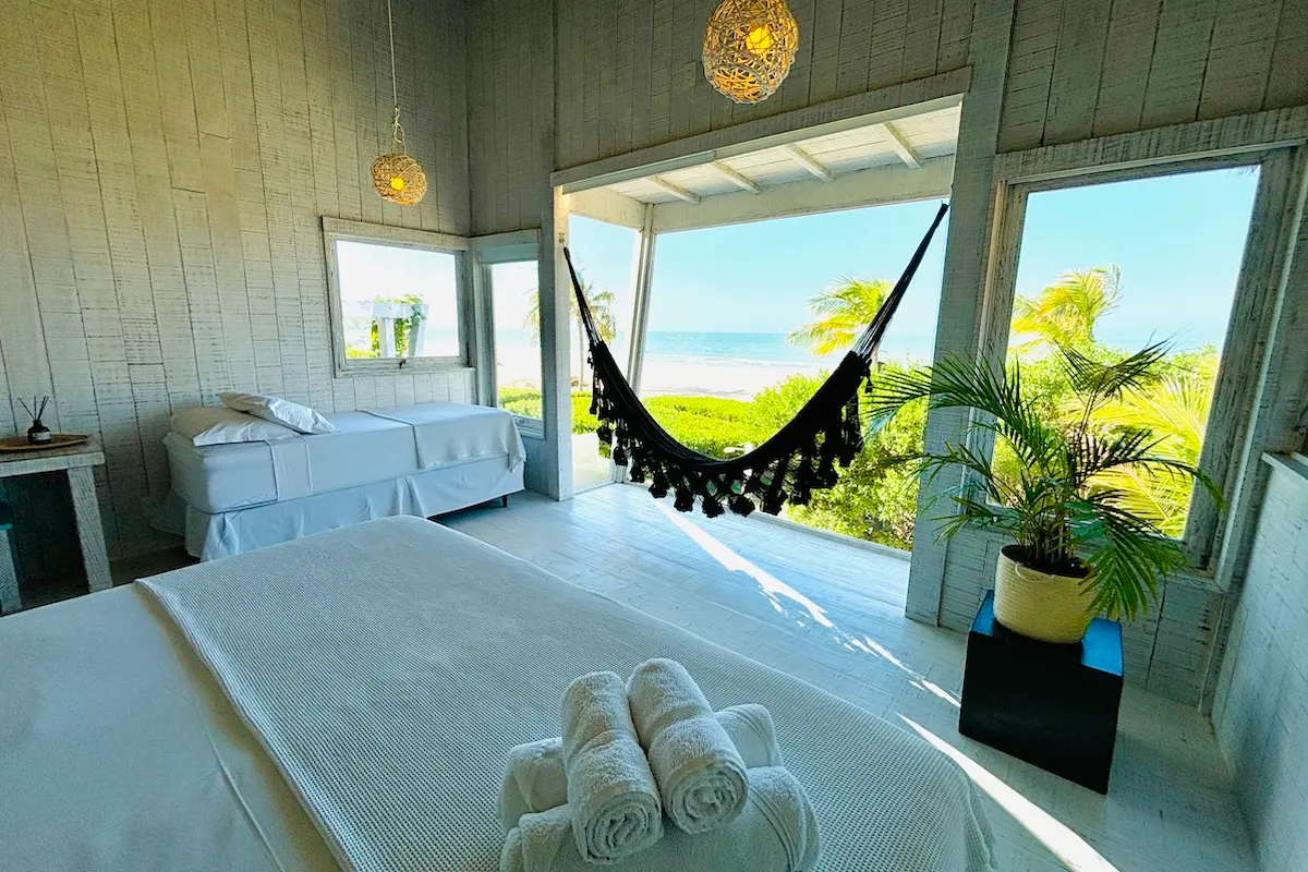 Bright twin bedroom with hammock and direct ocean view at Kite Sisters Brazil kitesurf retreat villa.
