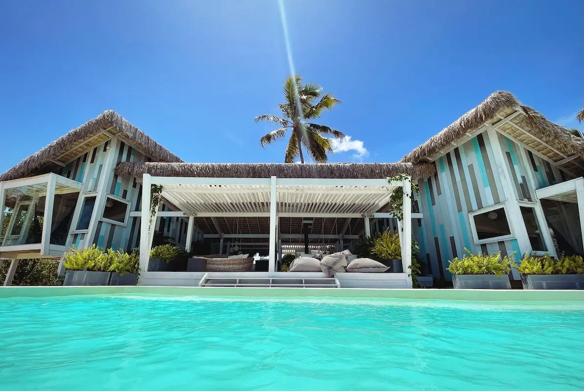 Kite Sisters Brazil kiteboarding retreat boutique villa with turquoise pool and thatched roof House.