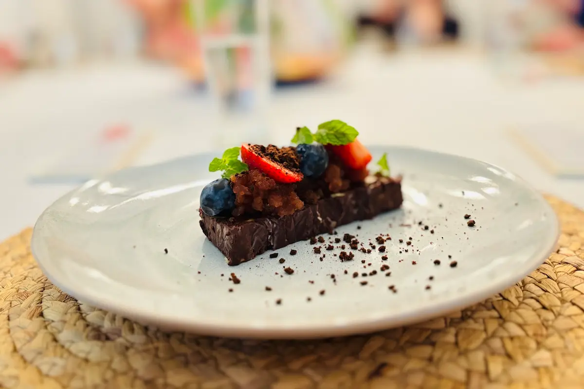Gourmet chocolate dessert with fresh berries and mint at Kite Sisters kitesurf retreat Belize fine dining.