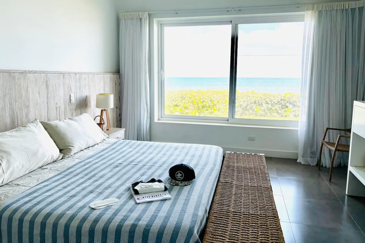 Bright ocean view bedroom with Kite Sisters welcome pack at women's kiteboarding camp Peru.